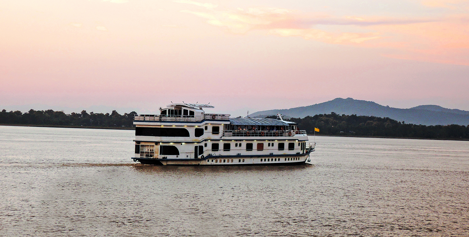 Ferry sailing over river Brahmaputra during sunset