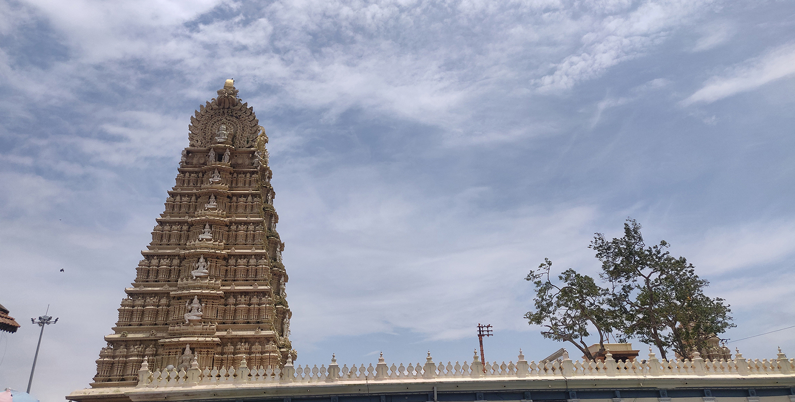 Landscape image of Sri Chamundeshwari Devi Temple with cloudy sky in the background