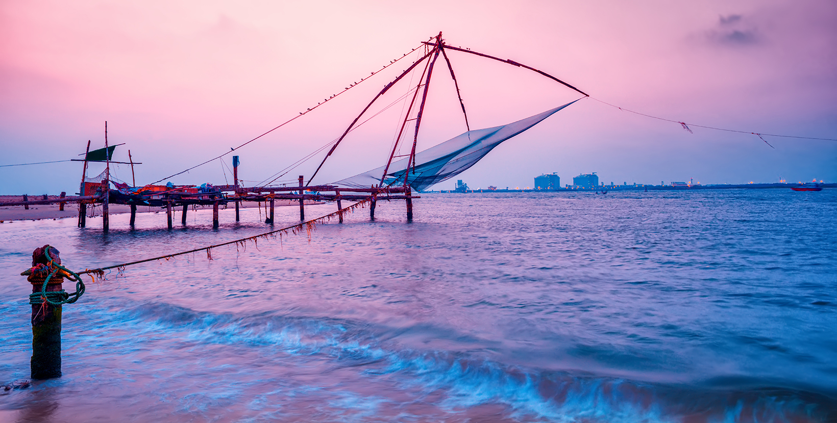 beautiful night scene of Kochi chinese fishnets in twilight Kochi, Kerala. Fort Kochin, Kochi, Kerala, south India, neon colors