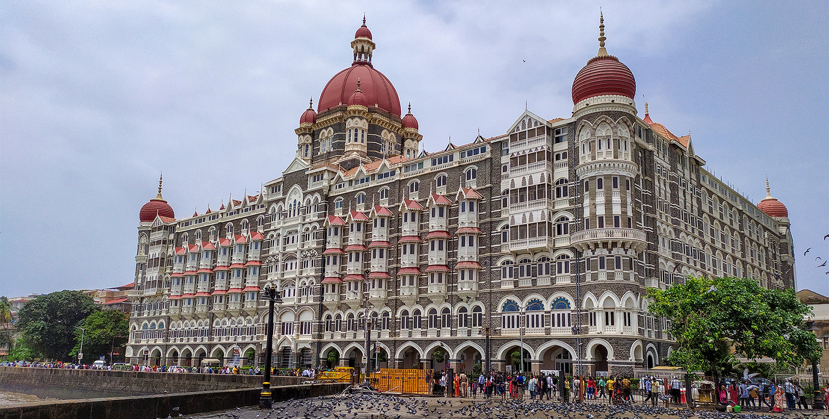 Mumbai, Maharashtra, India - August 11, 2019; The Taj Mahal Palace Hotel is a five-star luxury hotel located near Gateway of India Where lots of tourists are wandering and countless flocks of pigeons are sitting. Resorts & Palaces.