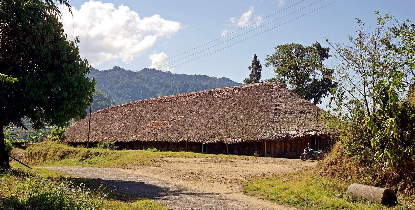 Longwa is located on a hill top between India and Myanmar. The nations border runs directly through the village and through the house of the Angh, the chief of Longwa. The villagers live in long huts, so called long houses that measure up to 80 metres.