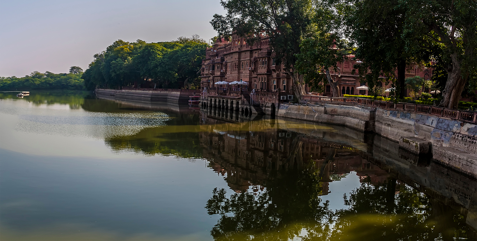 Reflections and serenity along the southern shore of Gajner lake in Rajasthan, India