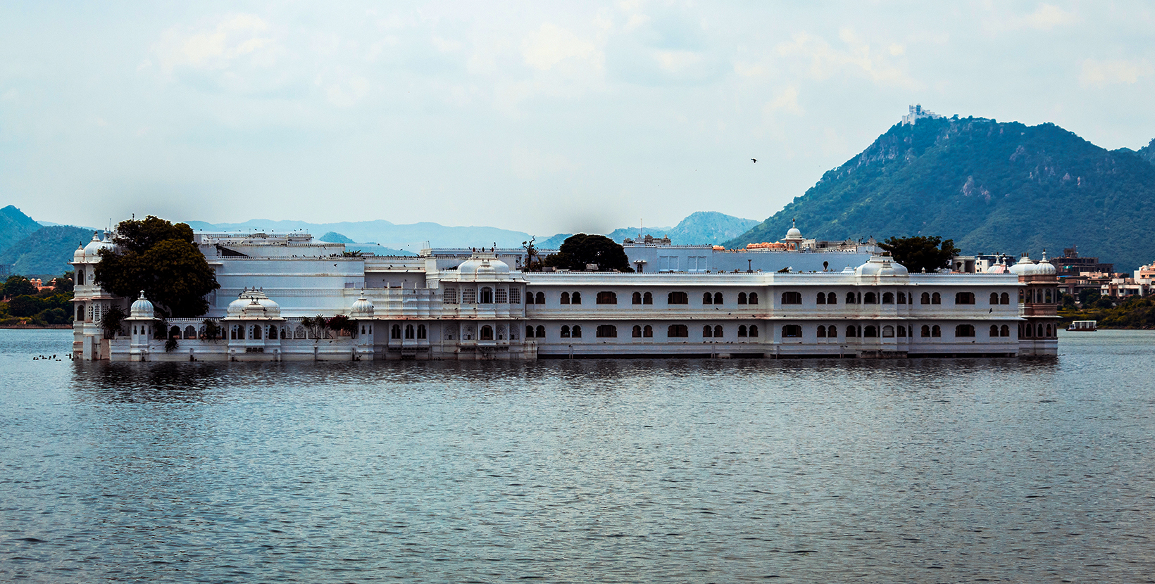 VIew of the Lake Palace, Udaipur in Lake Pichola as seen from the City palace in Udaipur, Rajasthan, India; Shutterstock ID 1526054075; purchase_order: -; job: -; client: -; other: -