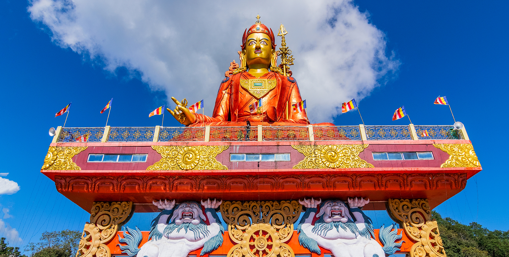 Holy statue of Guru Padmasambhava or born from a lotus, Guru Rinpoche, was a Indian tantric Buddhist Vajra master who taught Vajrayana in Tibet. Blue sky and white clouds, Samdruptse, Sikkim, India.